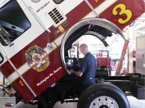 An employee working on a firetruck.